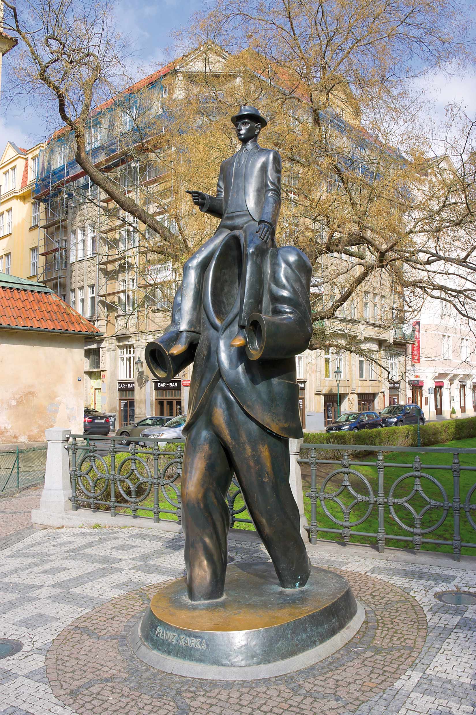 Today Kafka has become an emblem of Prague, commemorated throughout the city. Guides offer tours of “Kafka’s Prague,” in which this bronze statue by Jaroslav Rona – based on Kafka’s Description of a Struggle – is a highlight. Its location near Prague’s Spanish synagogue is also the area where Kafka lived most of his life 