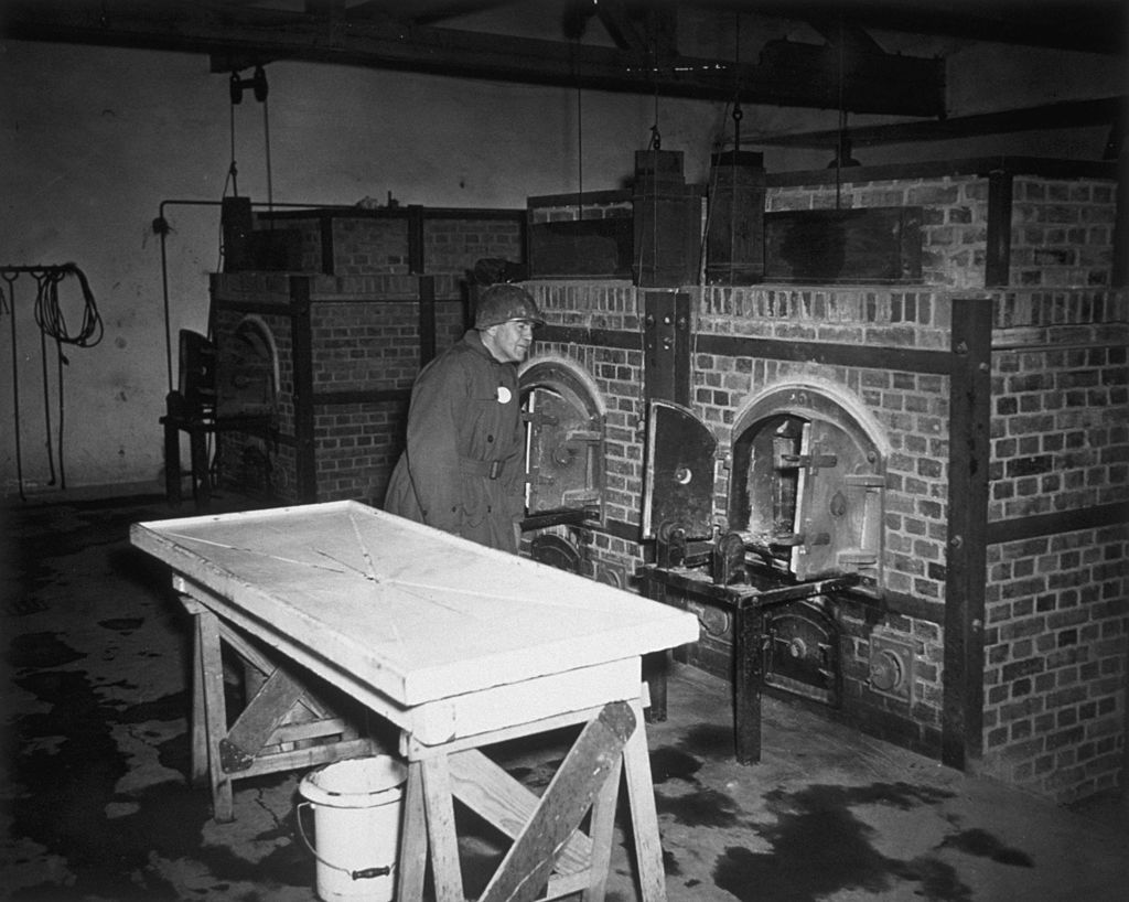 3rd May 1945: A member of the Congressional Party investigating atrocities in Germany, inspects one of the incinerators used to burn bodies in the Dachau Prison Camp
