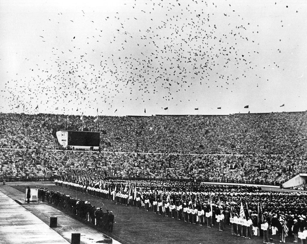 Thousands of carrier pigeons flying over the Olympic stadium in Helsinki. They were released during the opening ceremony to convey the news of the Games to other countries