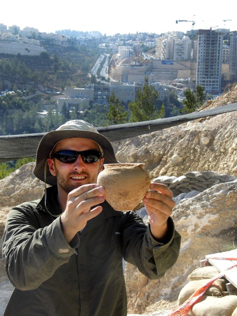 Alex Wigman presents a bowl removed from the ancient tomb