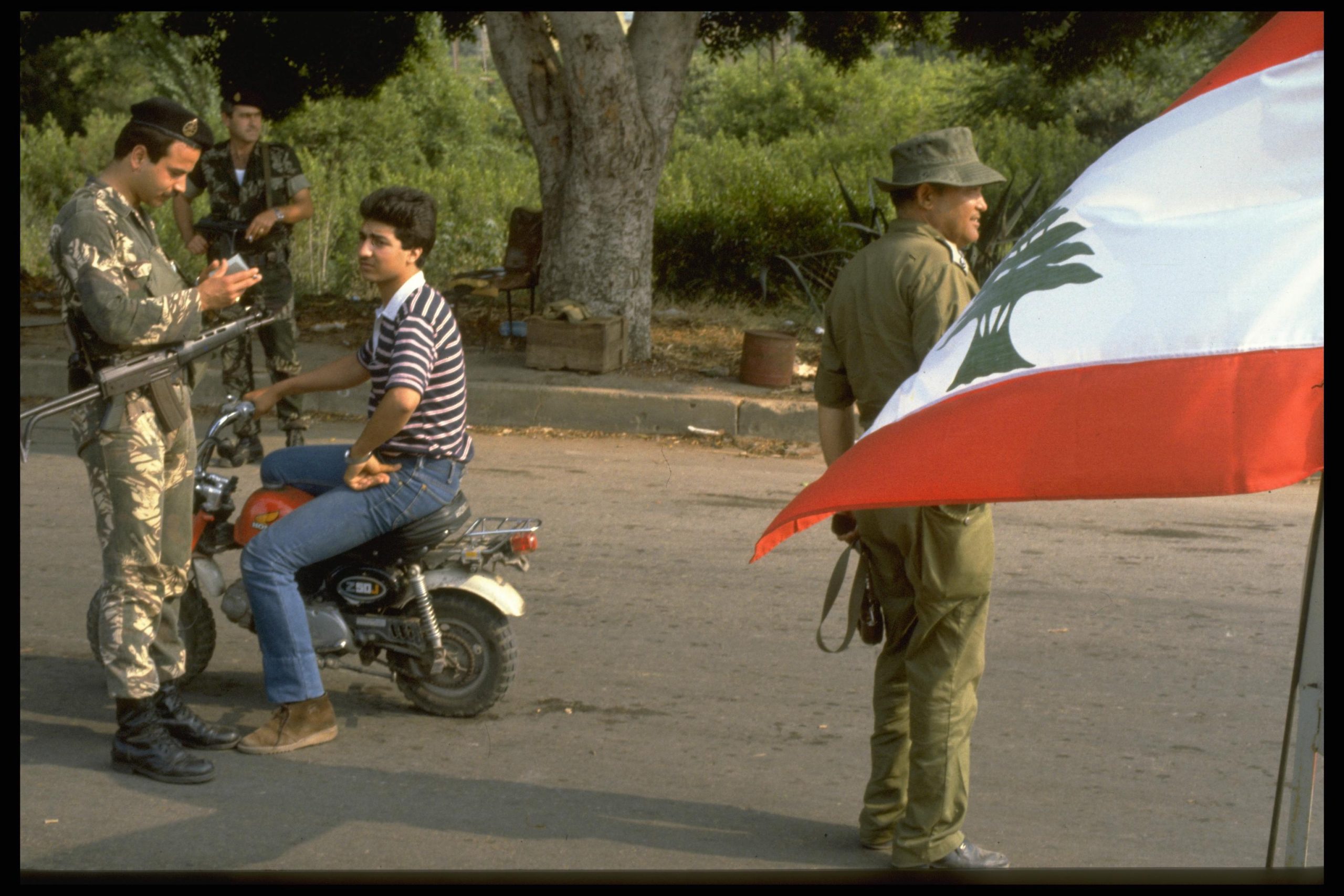 An IDF soldier searching a Lebanese citizen with a Christian militia member.