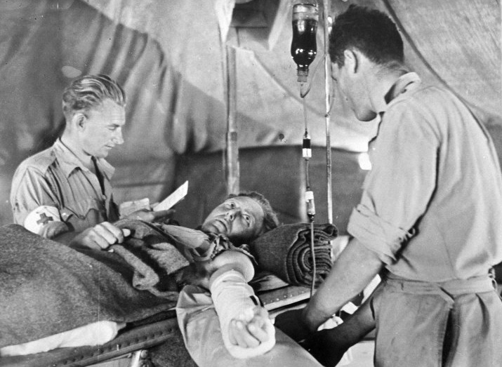 Lifesaving invention. A British soldier receives a blood transfusion at a field hospital 