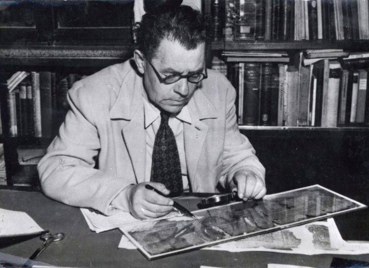 Professor Eliezer Sukenik examining one of the Dead Sea Scrolls, 1951