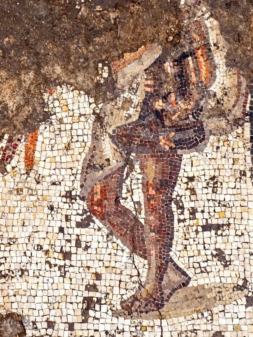 Figure in a short toga, one of three grouped together in the mosaic