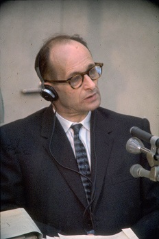 Close up of Nazi war-criminal Adolf Eichmann inside the reinforced glass cubicle built for his protection during the trial, Bet Ha'am, Jerusalem, 1961