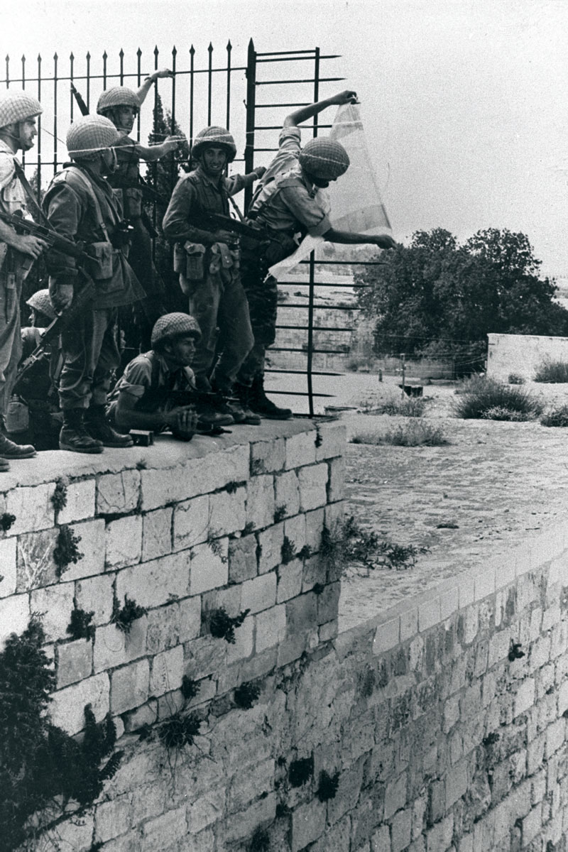 Uplifting moments. Yoram Zamosh and comrades hang the Israeli flag over the Western Wall