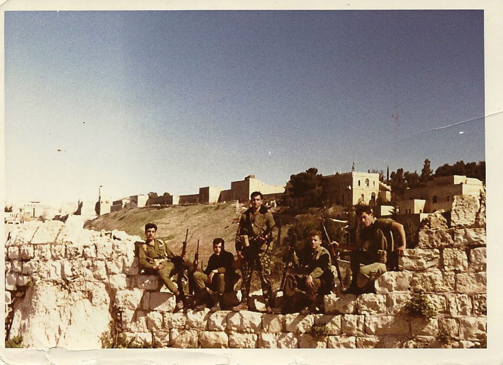 Armed Nahal soldiers stand guard above Ben Hinom Valley, beneath the Old City walls