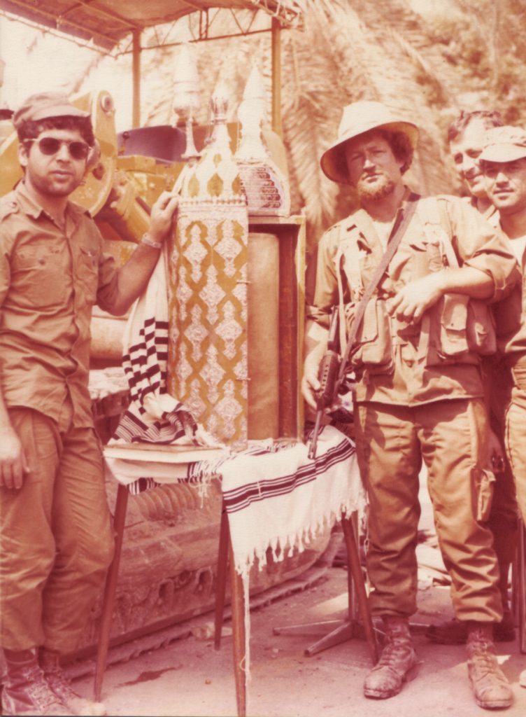  A sacred moment. Two paratroopers with the ancient Torah scroll, Sidon 1982