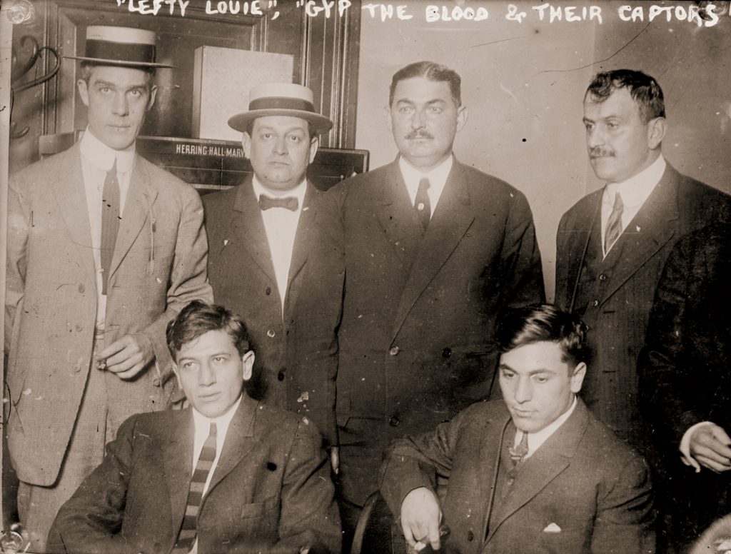 “Lefty Louie” Rosenberg and “Gyp the Blood” Horowitz (seated, left to right) with others implicated in the murder of Herman Rosenthal, proprietor of an alleged casino in New York City 