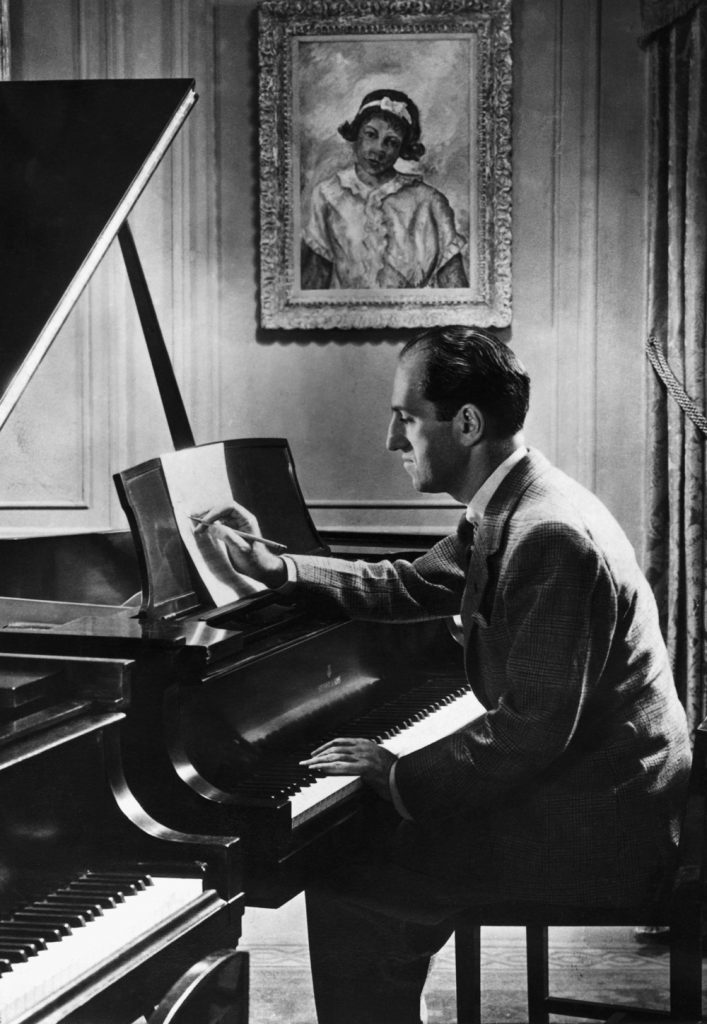 Few of his contemporaries saw the potential of black musical styles such as jazz. Gershwin at the piano. The painting of a black girl on the wall above him is his own work