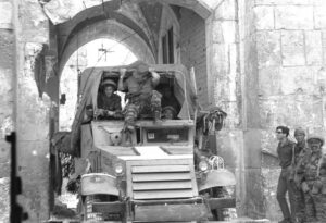 Command car passing through Lions’ Gate behind the advance attack force