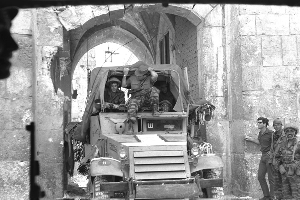 Command car passing through Lions’ Gate behind the advance attack force