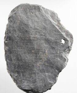 Centuries-old notes etched into soft stone. This slate, marked with names and sums of money, was presumably a debt ledger | Photo: © Stefan Arendt/LVR