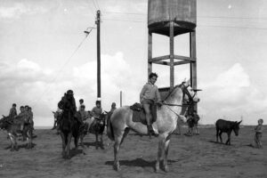 The focal point of every new settlement. Children by a water tower in Kfar Vitkin (near Netanya), 1935