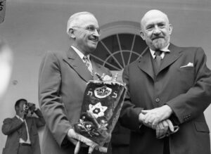 Harry Truman holding the Torah scroll given him by Chaim Weizmann on the latter’s first visit to the White House as president of the State of Israel, late spring 1948 | Photo: Bettmann/Getty Images